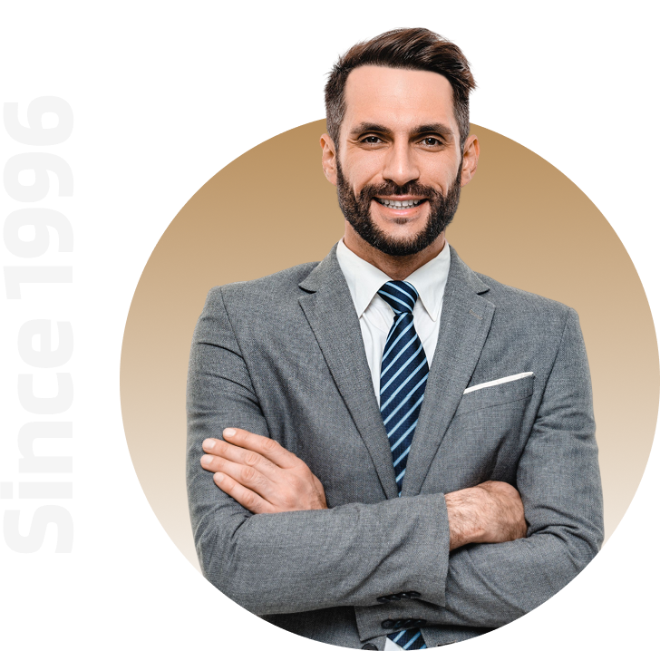 Man in suit smiling with crossed arms.